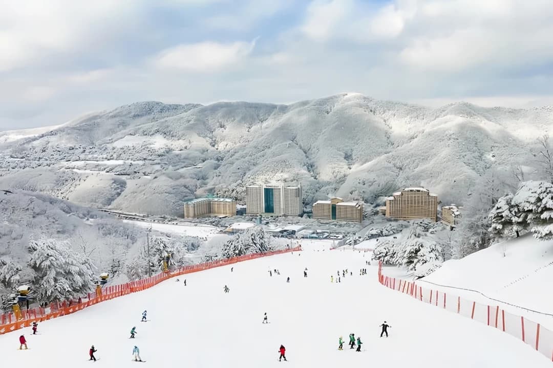 Wide slope with skiers and resort hotels at the foot of the mountain, Vivaldi Park, Hongcheon